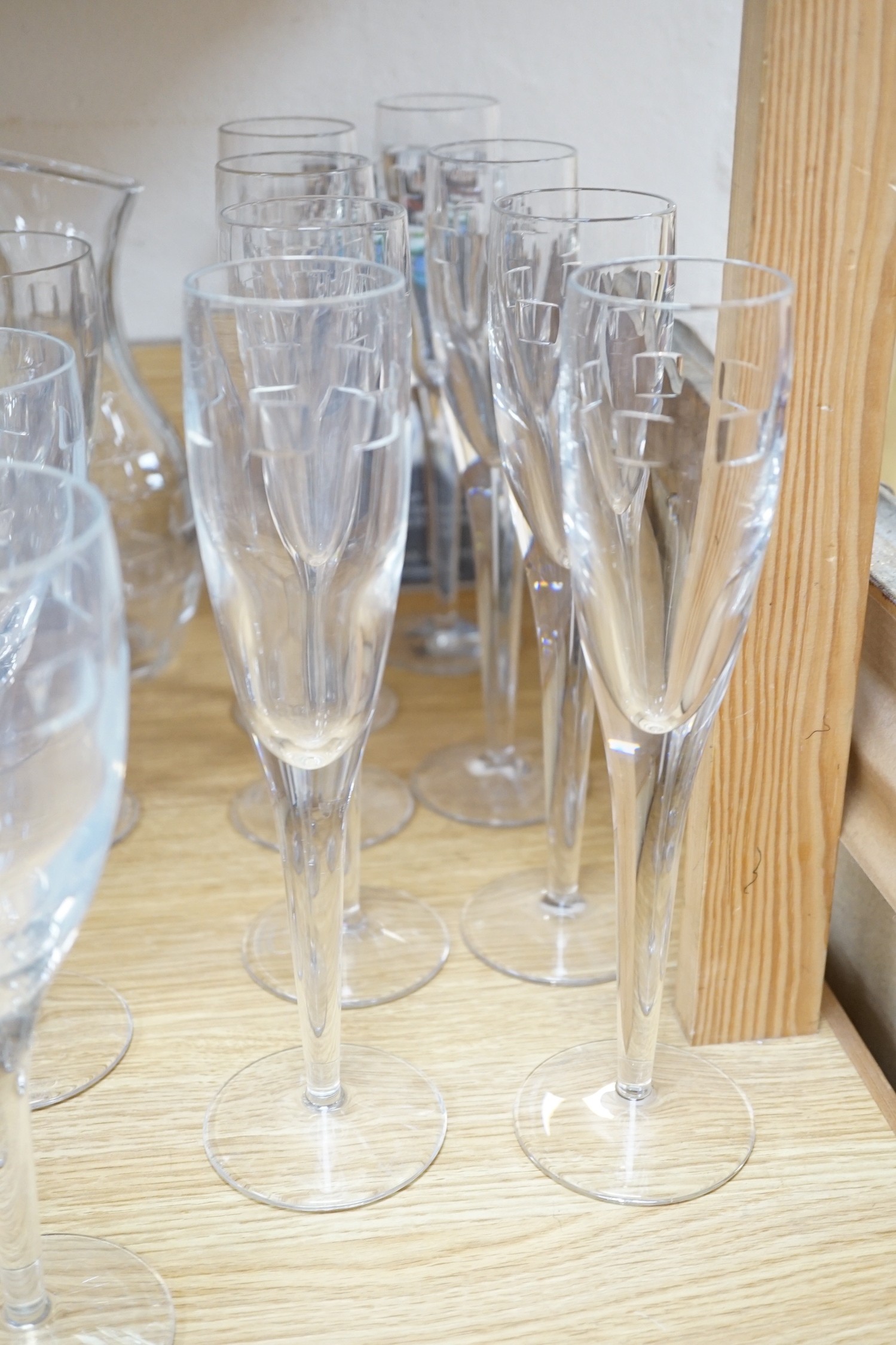 John Rocha for Waterford. A set of 8 cut glass flutes with six matching tumblers, three goblets and a carafe